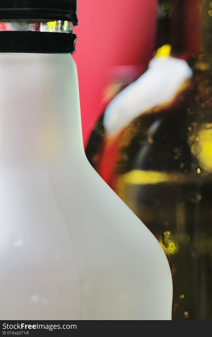 Wine bottles on the red background. Narrow depth of field. Wine bottles on the red background. Narrow depth of field.