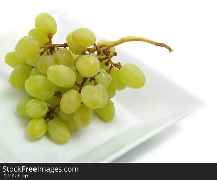 Fresh bunch of green grapes in white bowl and isolated on white background. Fresh bunch of green grapes in white bowl and isolated on white background