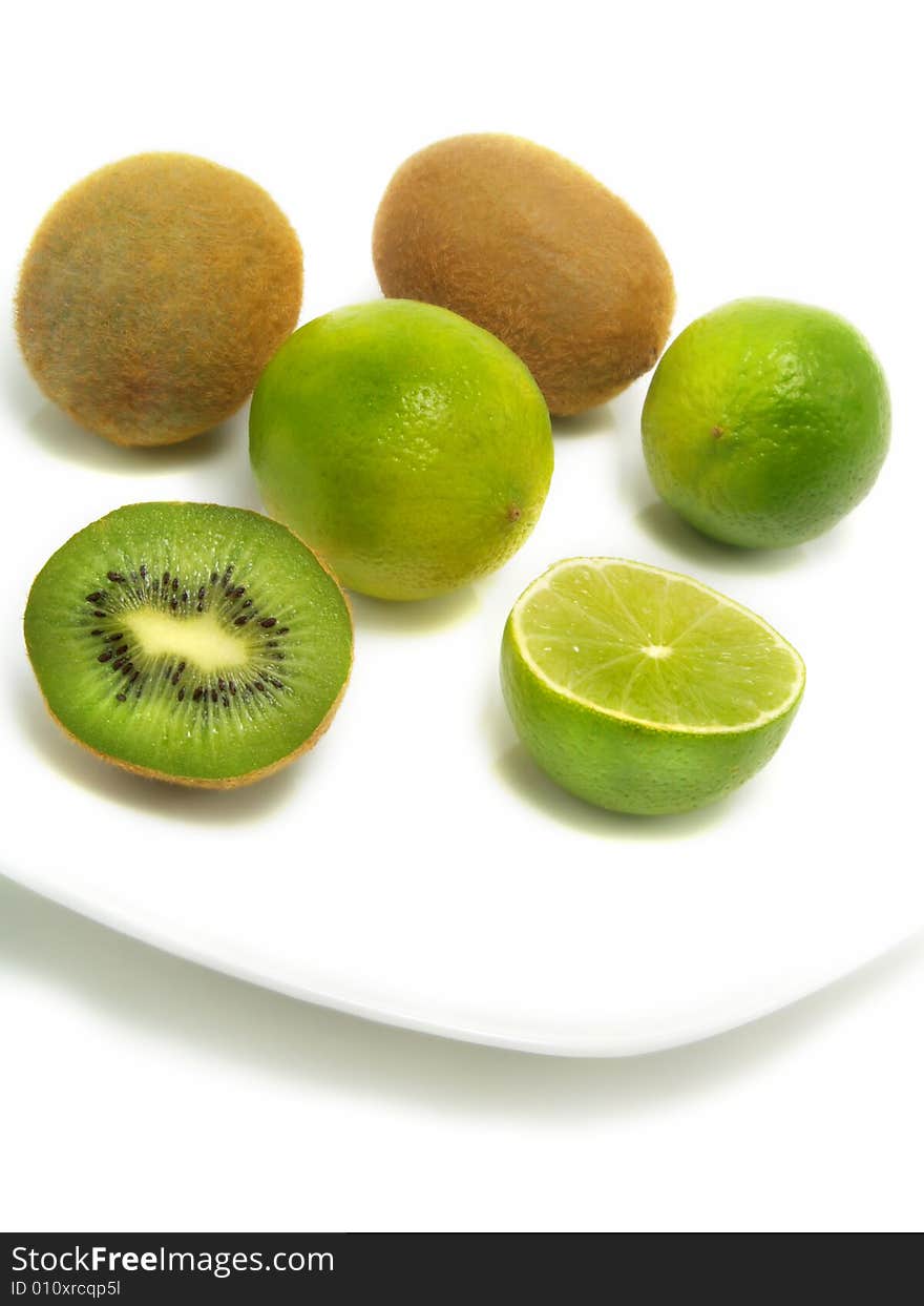 Kiwis and limes on plate