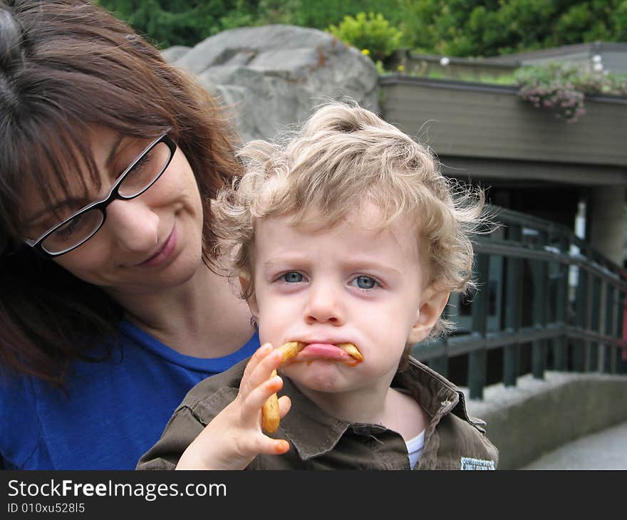 Mother and son eating french fries