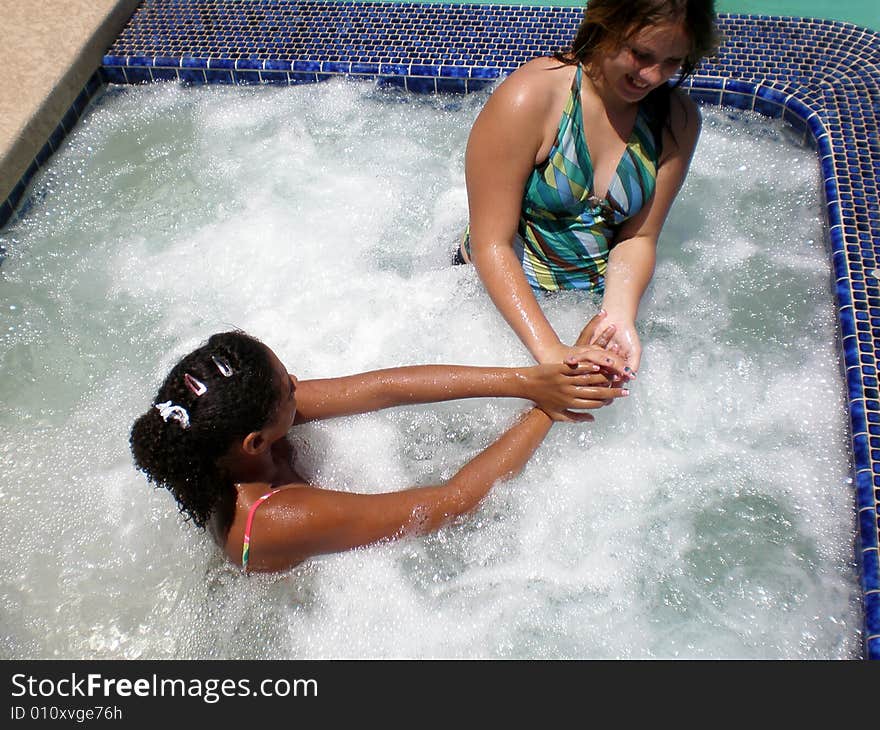 A picture of two girls who are best friends playing in jacuzzi. A picture of two girls who are best friends playing in jacuzzi.