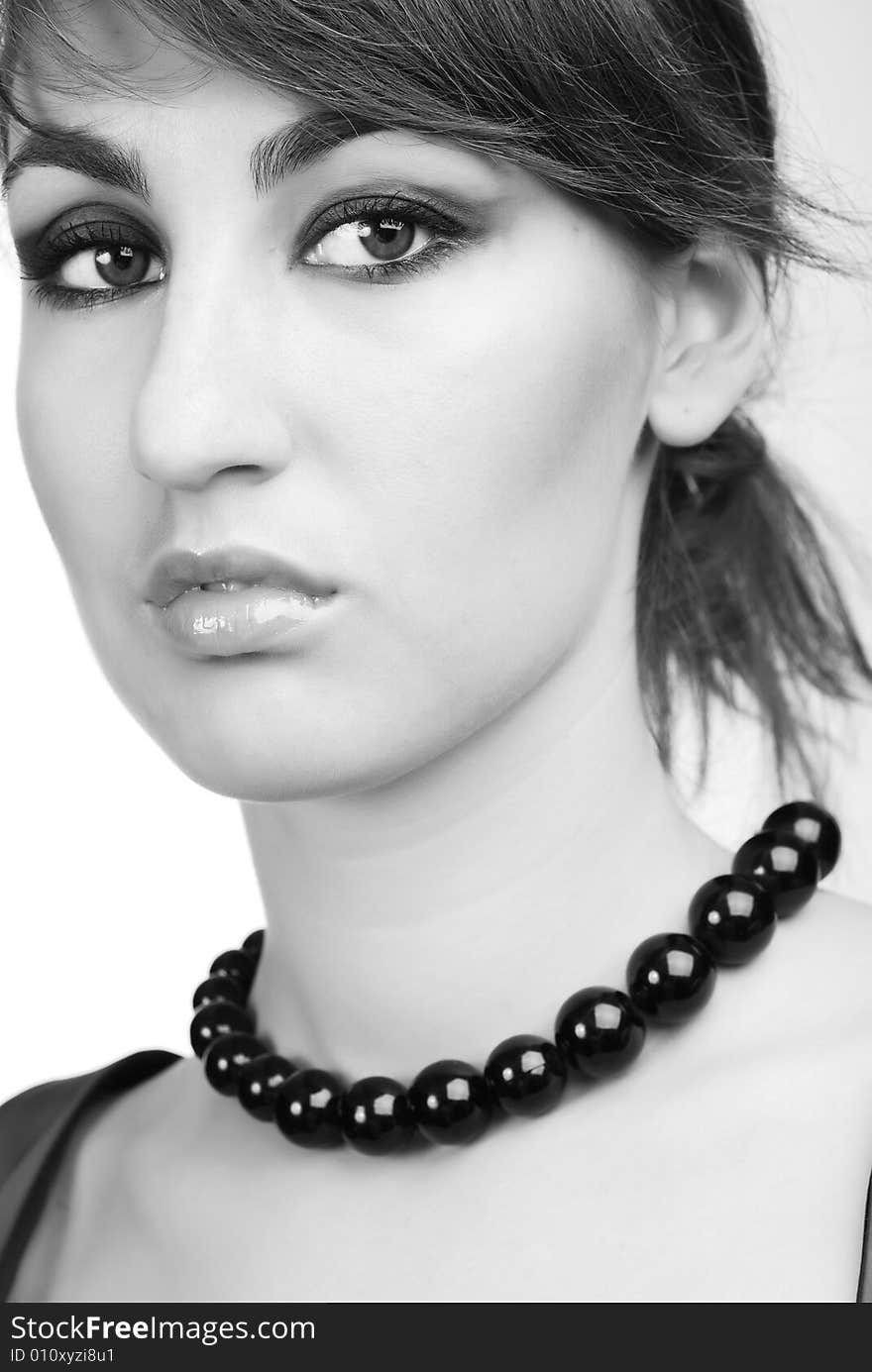 Portrait of young girl with black beads on her neck