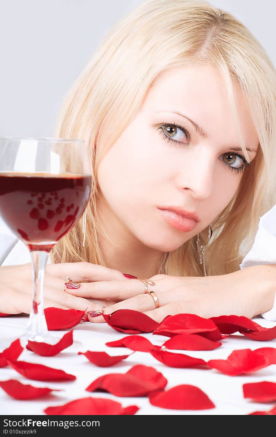 Cute blonde with wine and petals. Cute blonde with wine and petals