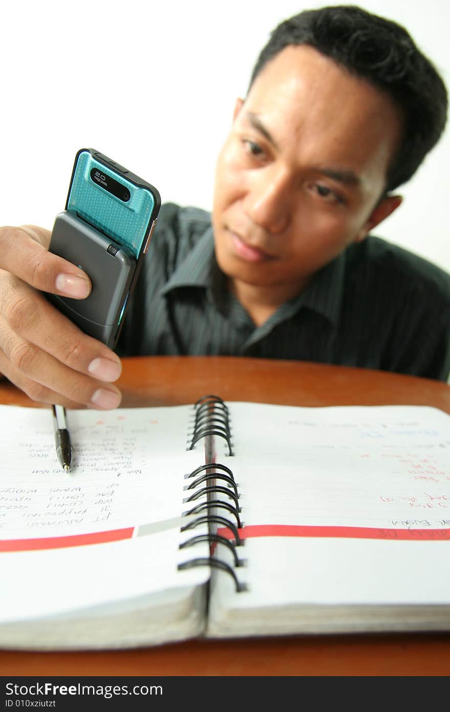 Man with homework difficulty and use mobile phone for help