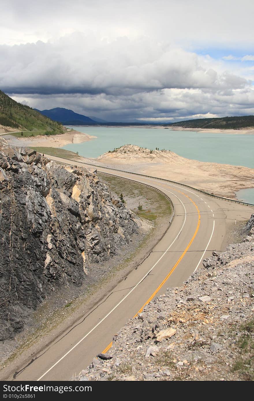 A highway winding along a mountain lake in the Canadian Rockies. A highway winding along a mountain lake in the Canadian Rockies