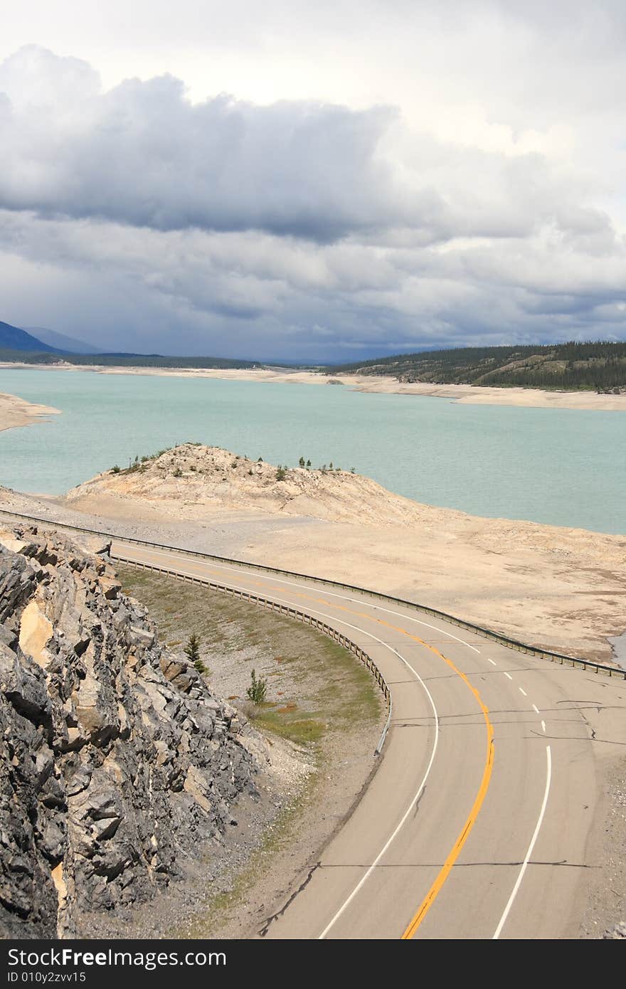 A highway winding along a mountain lake in the Canadian Rockies. A highway winding along a mountain lake in the Canadian Rockies