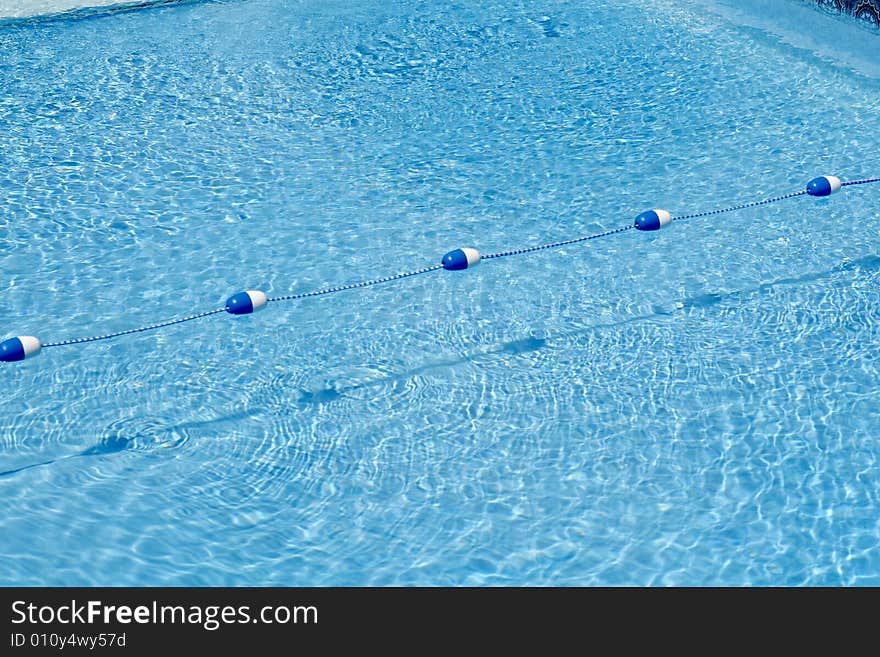 Close-up shot of a buoy rope dividing a swimming pool. This rope divides the shallow end from the deep end. Close-up shot of a buoy rope dividing a swimming pool. This rope divides the shallow end from the deep end.