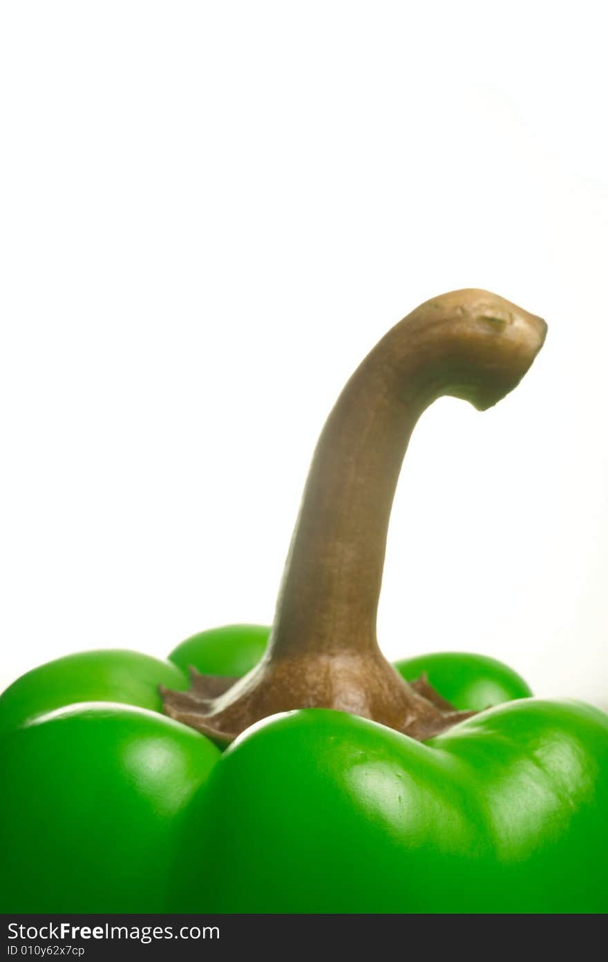 Closeup of top of fresh green bell pepper on white