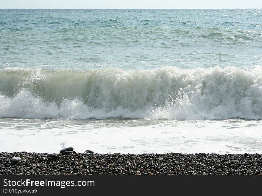 Wave on sea beach under year blue sky and cloud