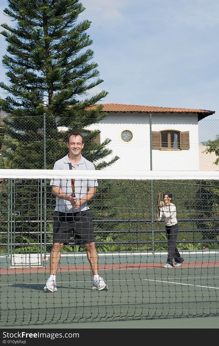 Couple Playing Tennis - Vertical