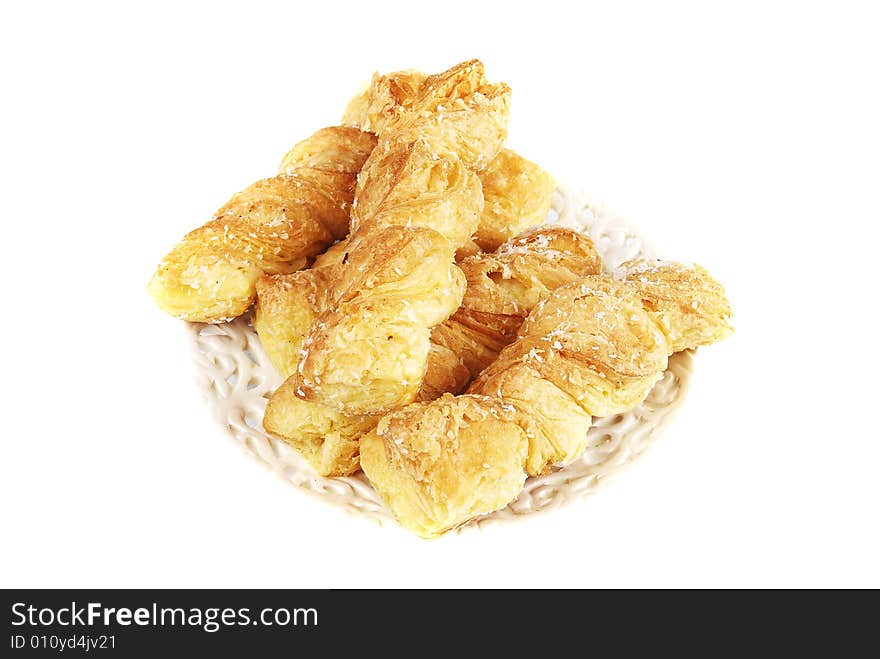 Fresh puff rolls on a plate on a white background