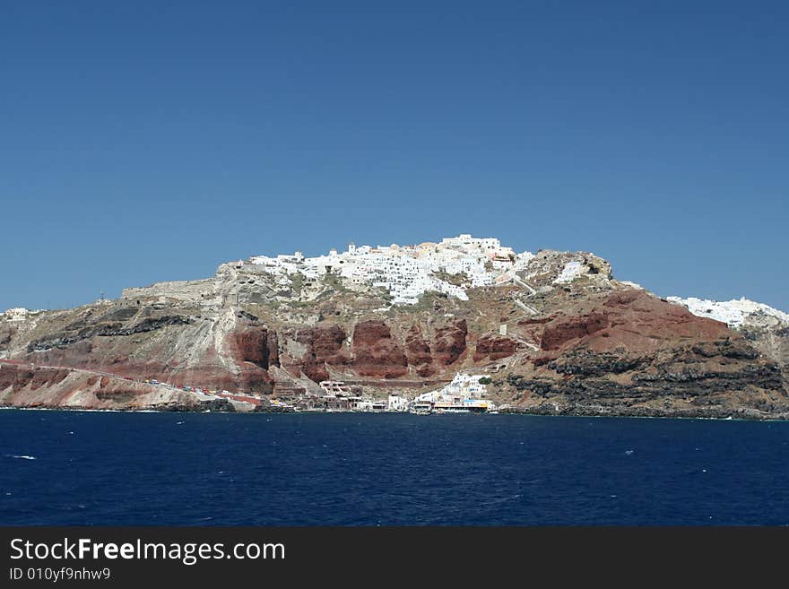 Vibrant coastal town perched on volcanic rock in Greece. Vibrant coastal town perched on volcanic rock in Greece.