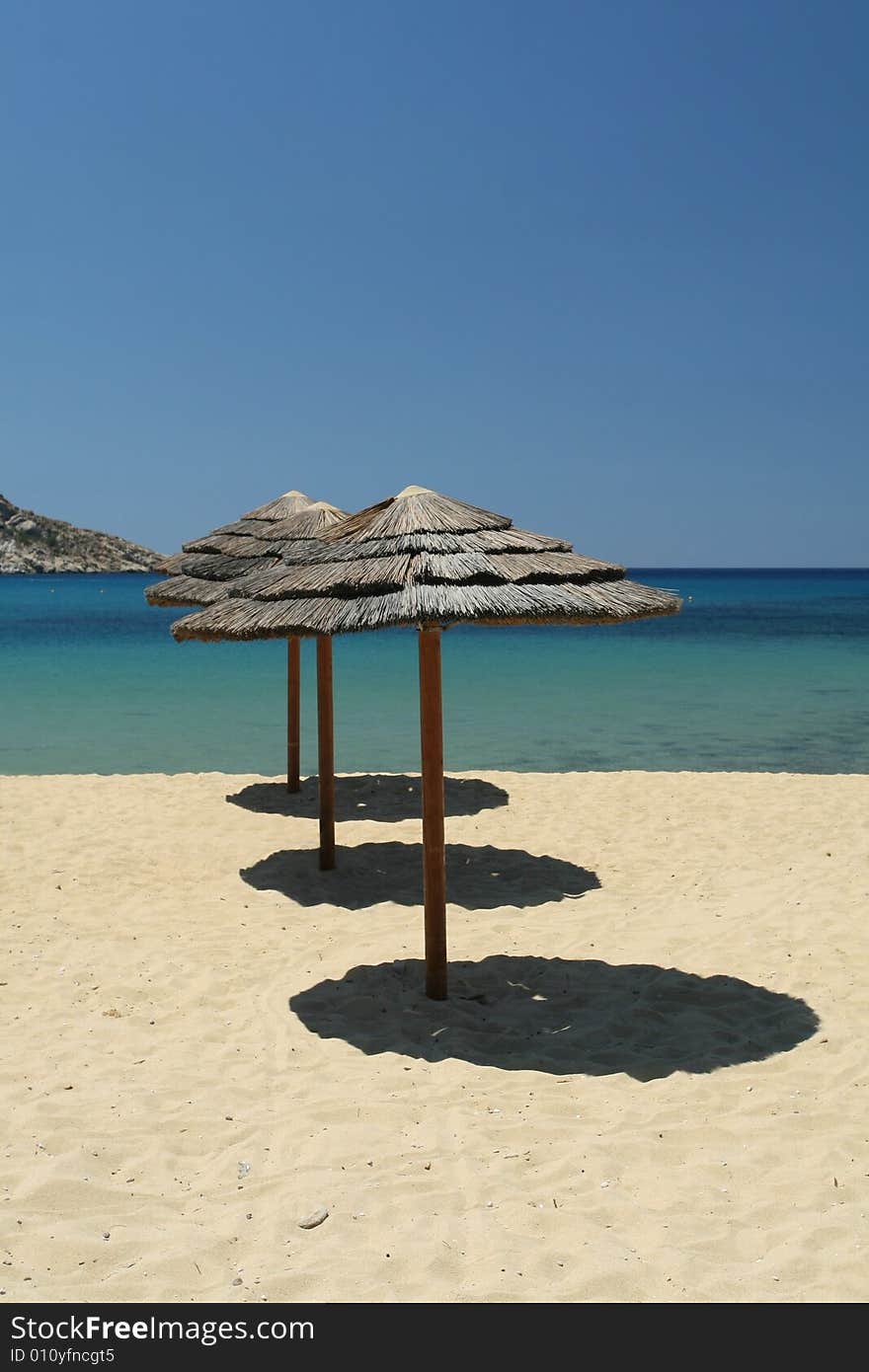 Stunning tropical beach setting with beach umbrellas. Stunning tropical beach setting with beach umbrellas.