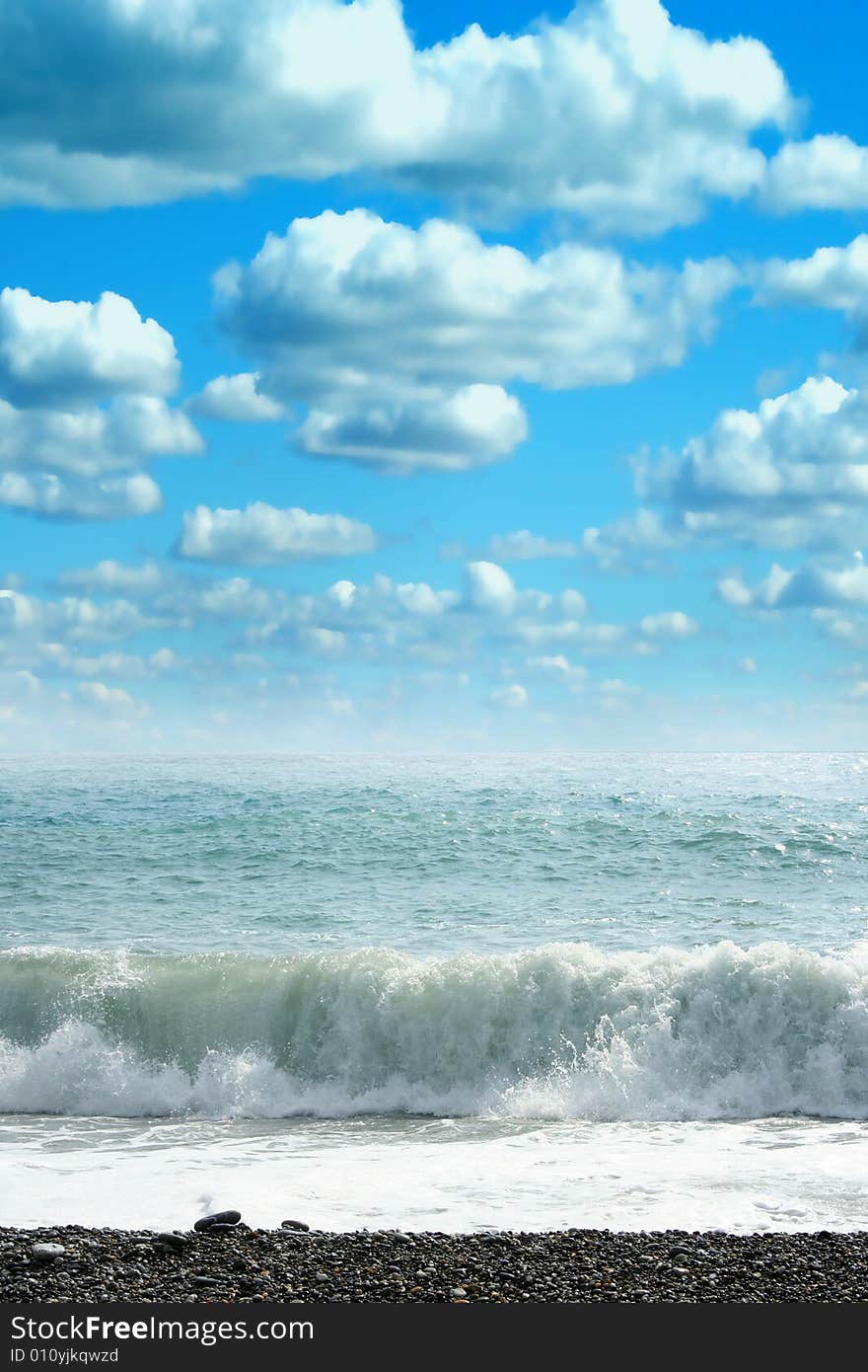 Wave on sea beach under year blue sky and cloud