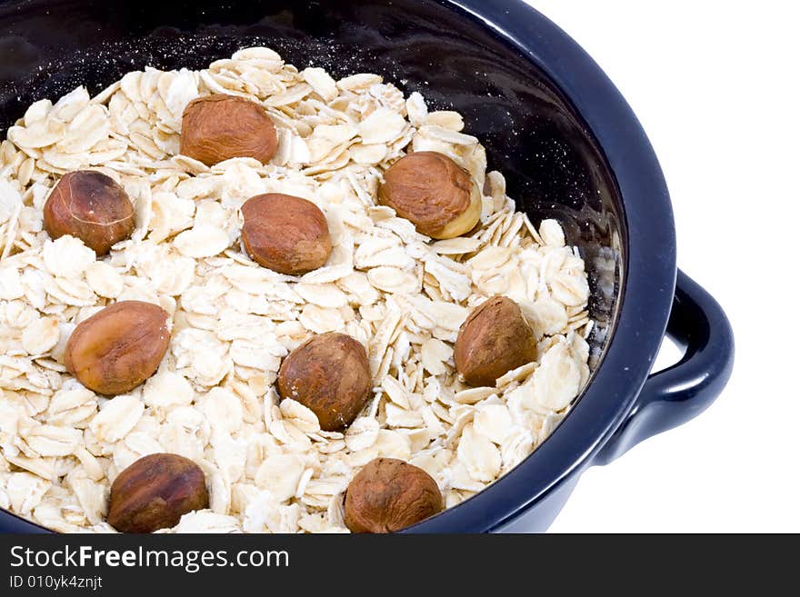 A bowl of oatmeal with hazelnuts - healthy diet