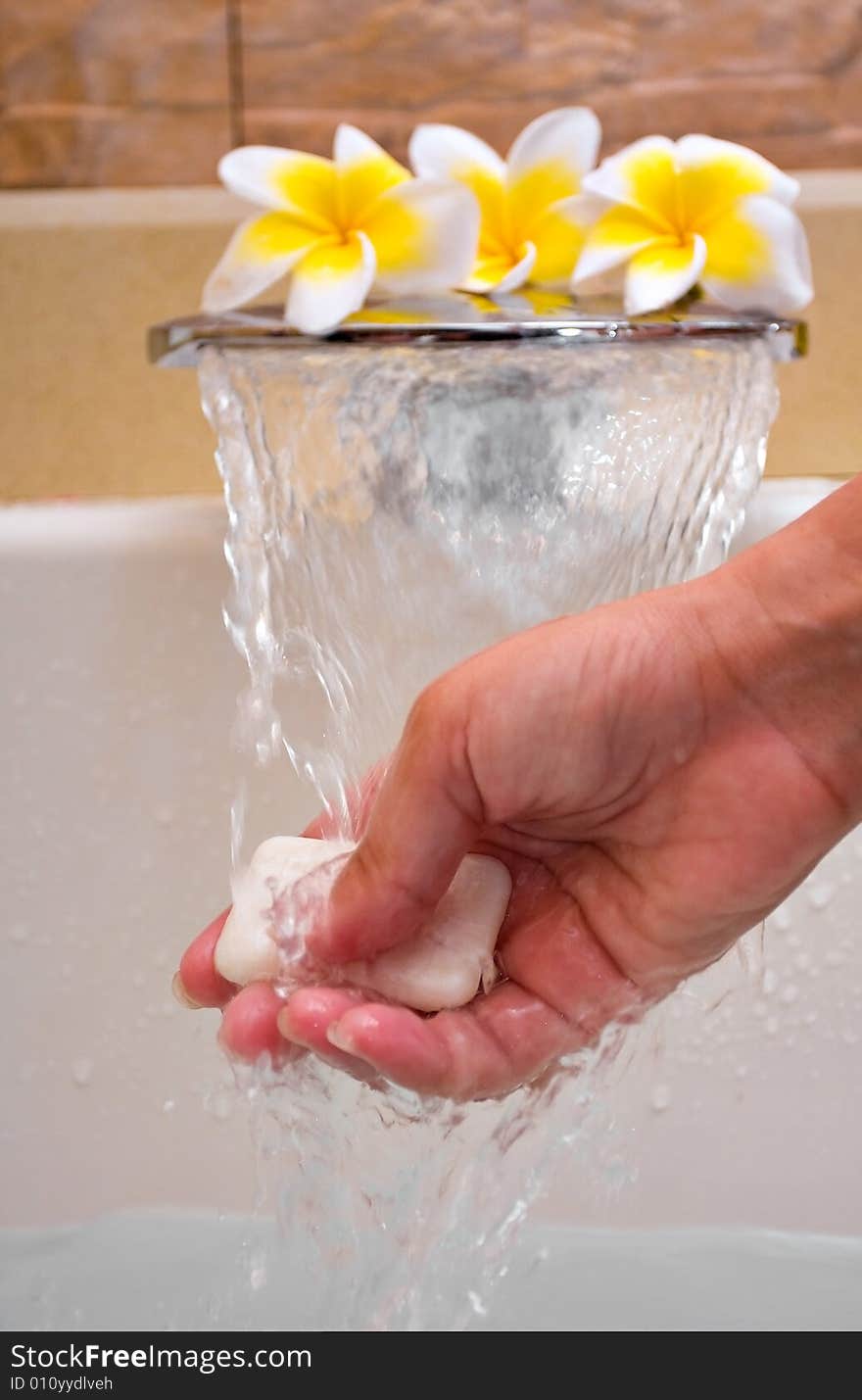 Hand holding soap under water