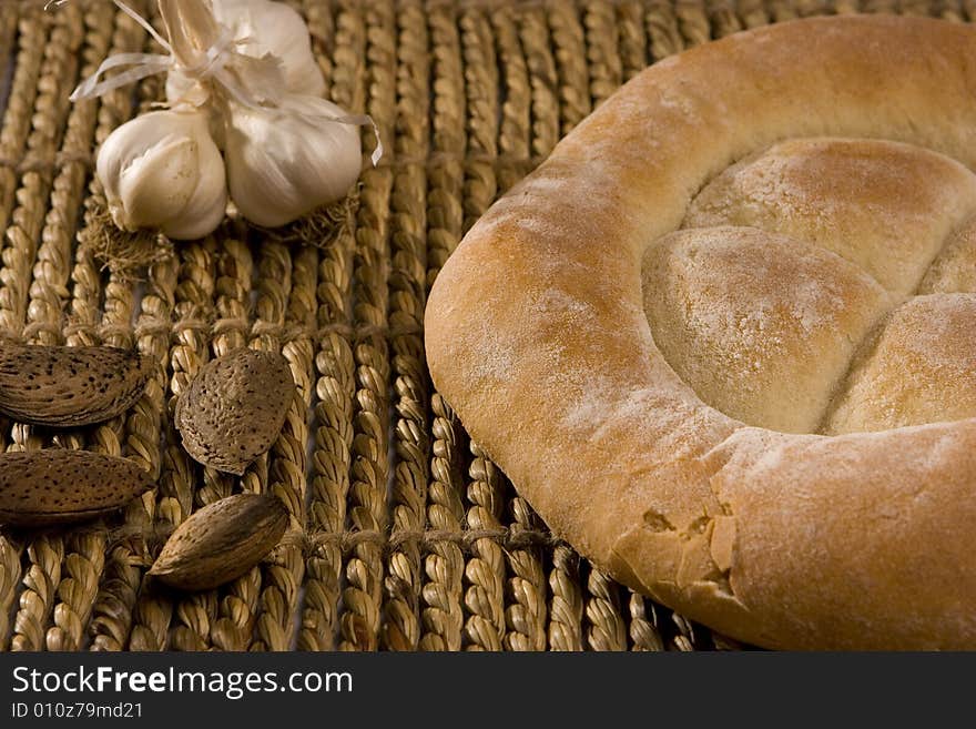 Made in the studio, bread, garlic and almonds isolated on wood; healthy food