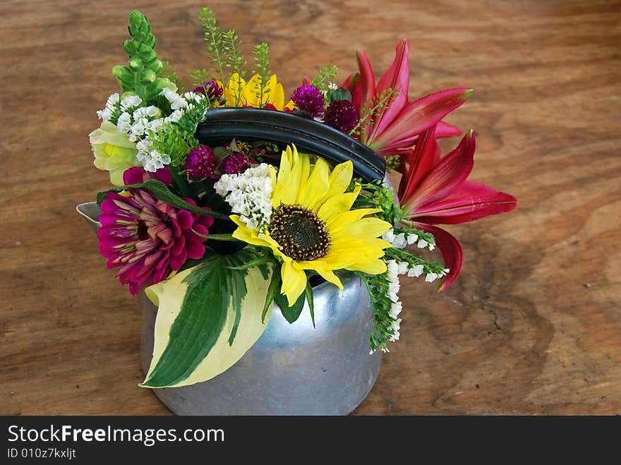 Retro tea kettle filled with summer flowers. Retro tea kettle filled with summer flowers.