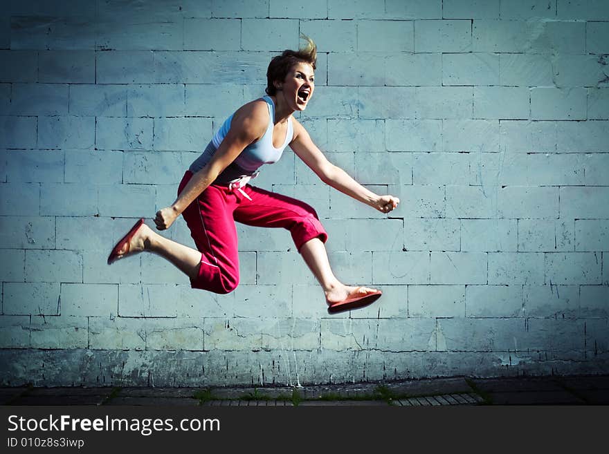 Young girl jumping and screaming. Young girl jumping and screaming.