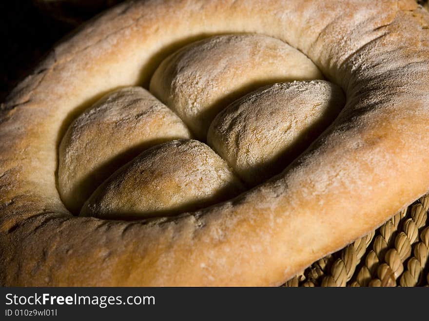 Made in the studio, bread isolated on wood and black; healthy food. Made in the studio, bread isolated on wood and black; healthy food