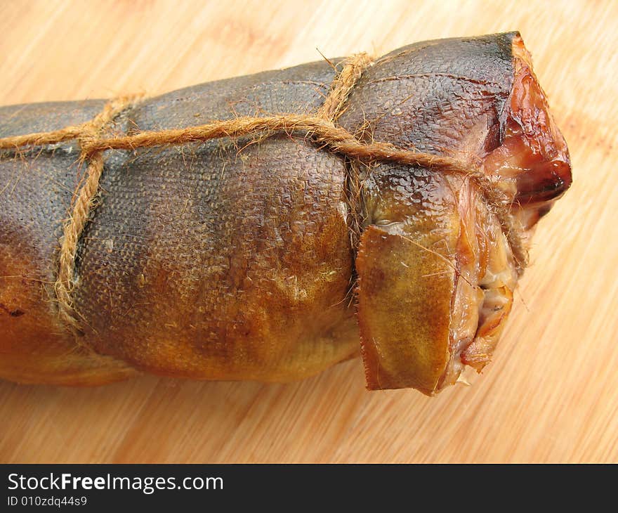 A hot smoked fish on the wooden board