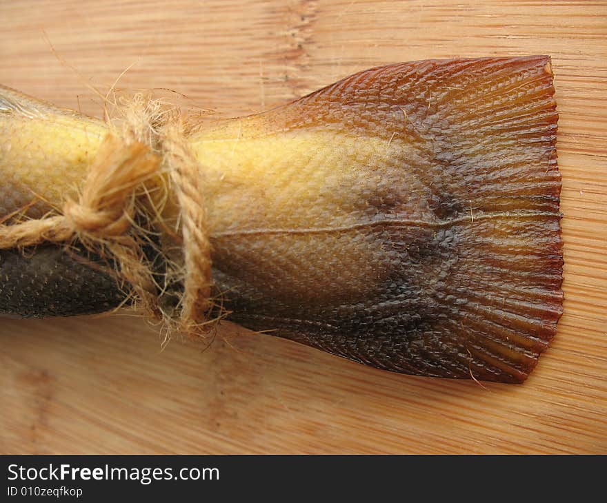 A hot smoked fish on the wooden board