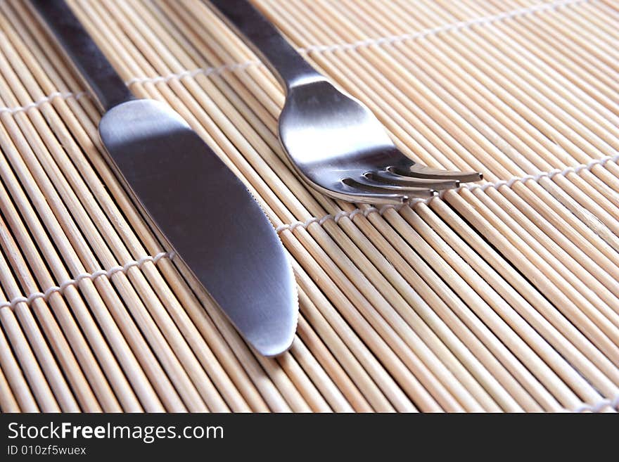 Fork an knife on bamboo  mat