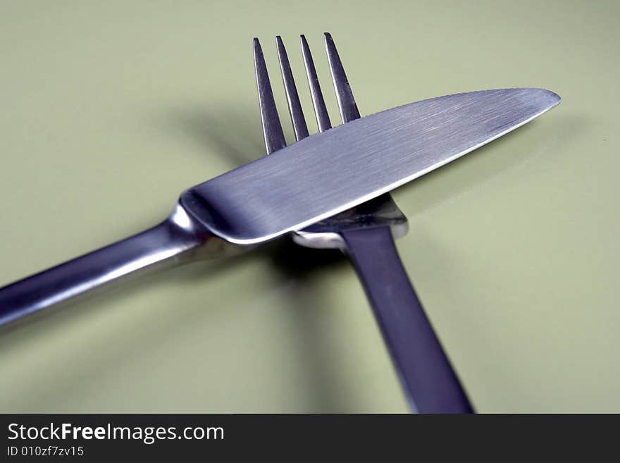 Fork And Knife On Green Plate