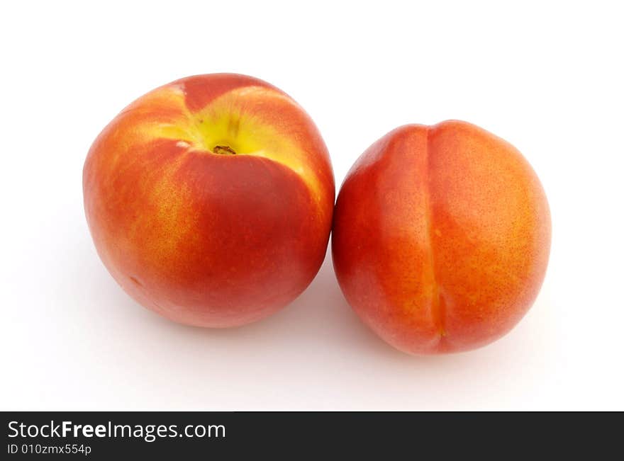 A photograph of nectarines against a white background