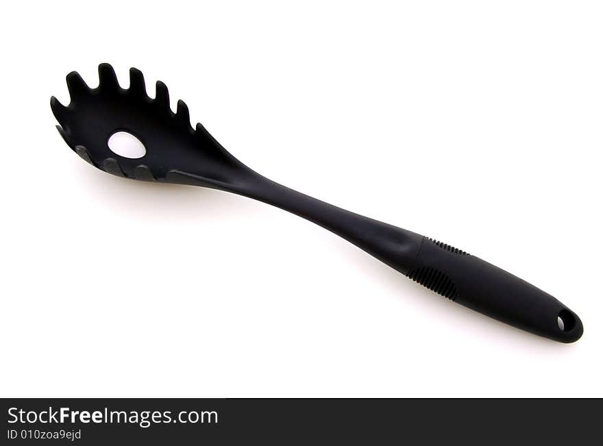 A photograph of a pasta scoop against a white background