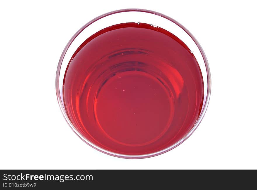 A photograph of cranberry juice in a glass against a white background