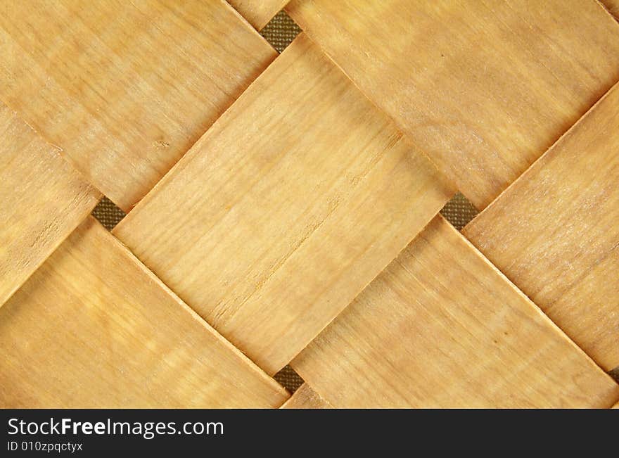 A photograph of a wood basket against a white background