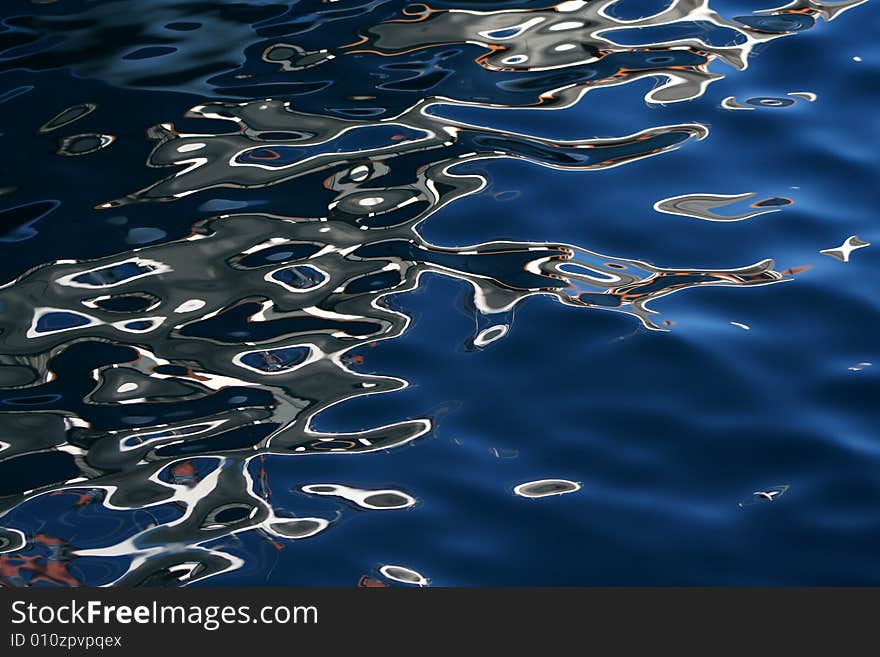 Seawater with a boats reflections