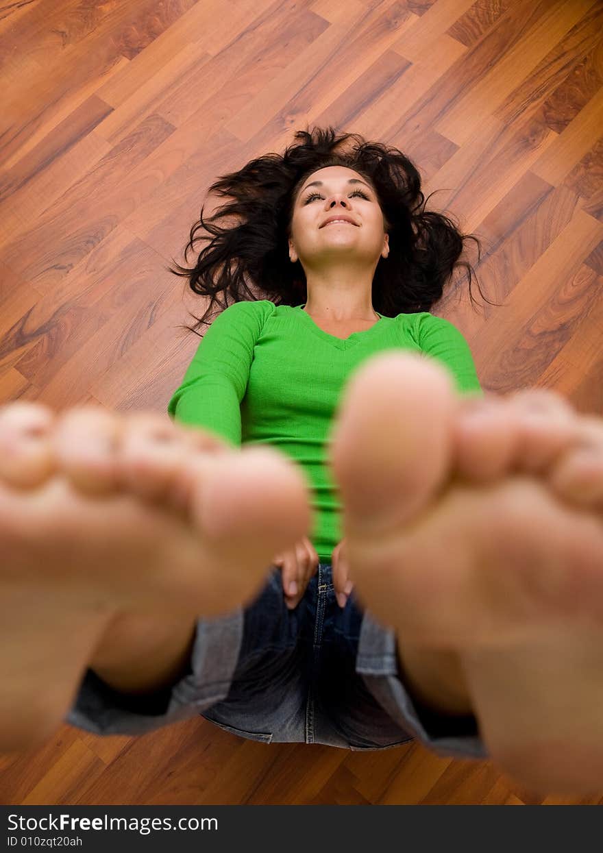 Brunette woman lying on the floor. Brunette woman lying on the floor