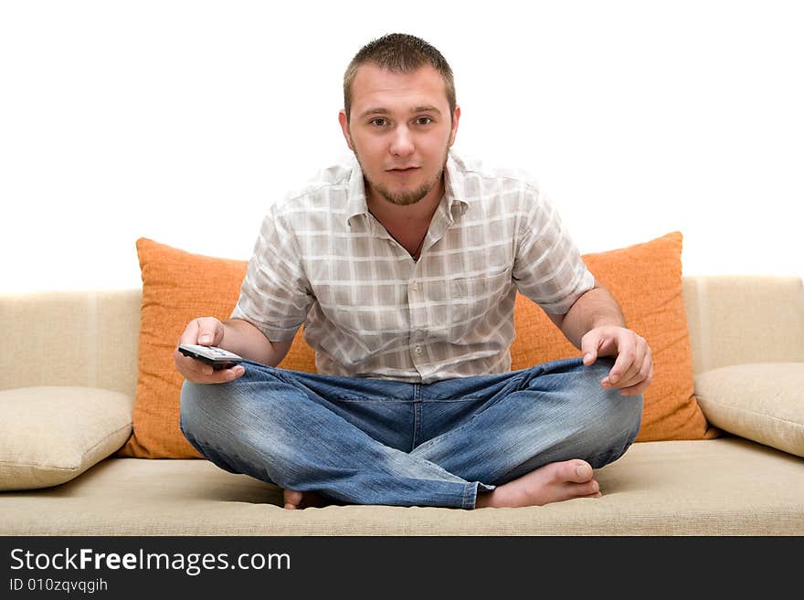 Casualman sitting on sofa with remote control. Casualman sitting on sofa with remote control