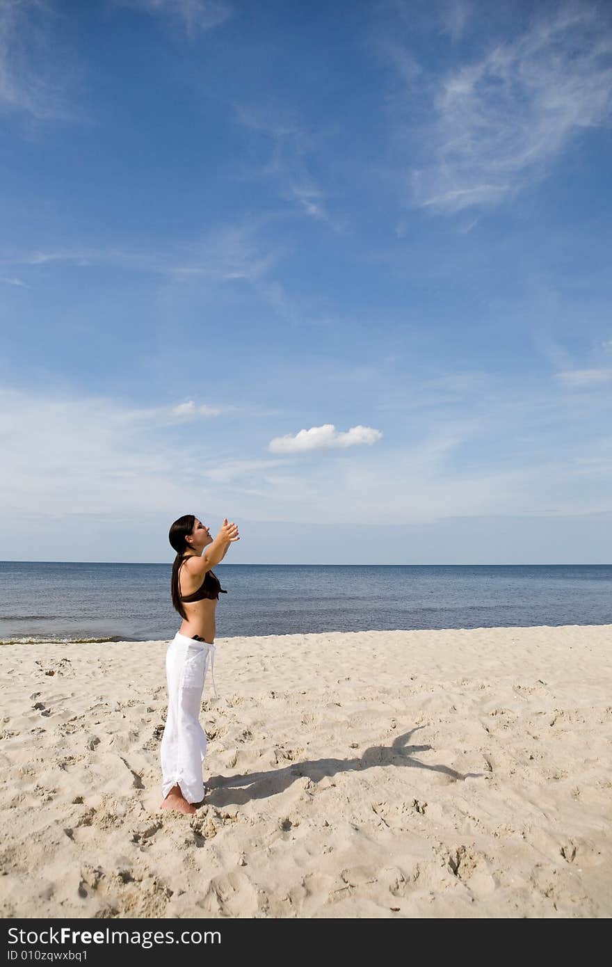 Attractive brunette woman relaxing on beach. Attractive brunette woman relaxing on beach