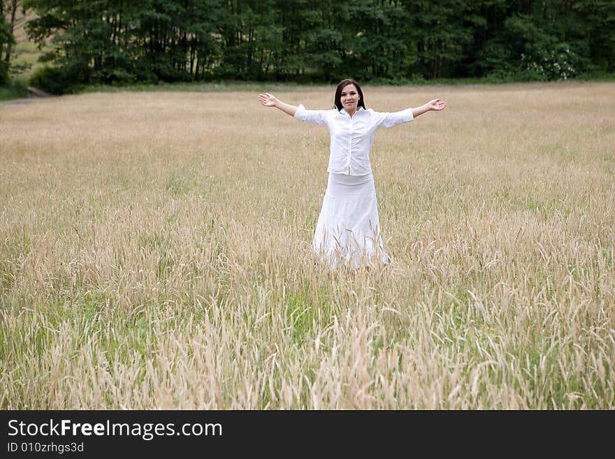 Attractive brunette woman relaxing on meadow. Attractive brunette woman relaxing on meadow