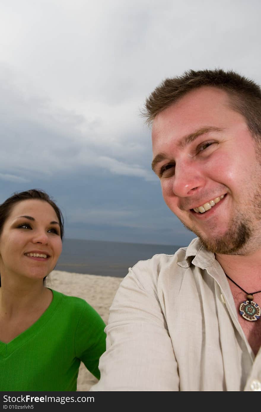 Active couple relaxing on the beach. Active couple relaxing on the beach