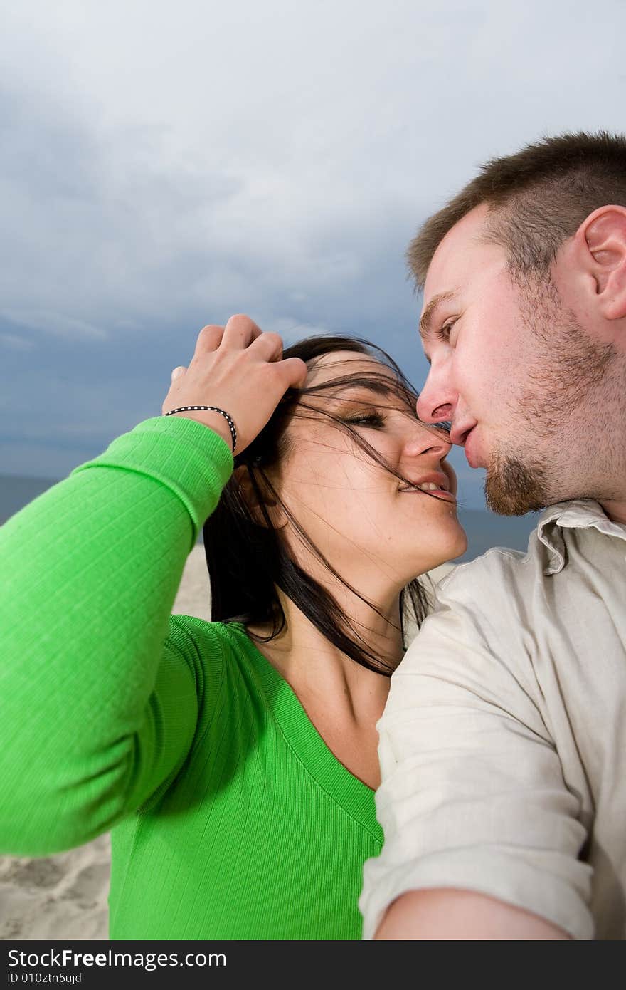 Active couple relaxing on the beach. Active couple relaxing on the beach