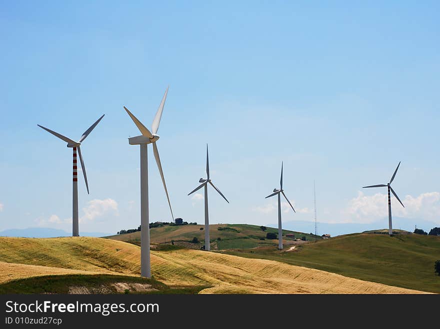 Windmills on a hill in summer day