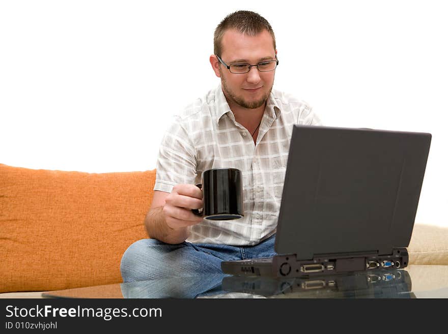 Happy man sitting on sofa with laptop. Happy man sitting on sofa with laptop