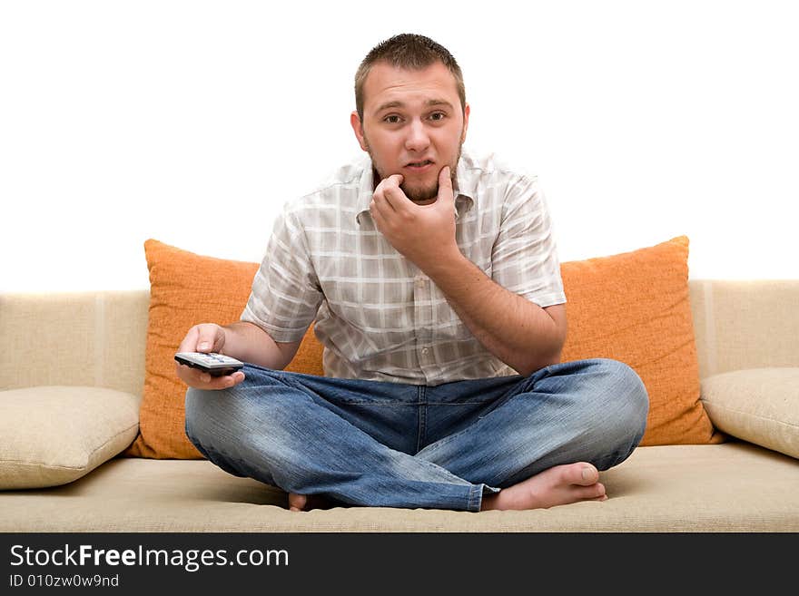 Casualman sitting on sofa with remote control. Casualman sitting on sofa with remote control