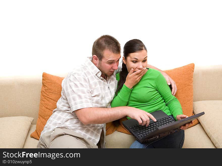 Happy couple sitting on sofa with laptop. Happy couple sitting on sofa with laptop