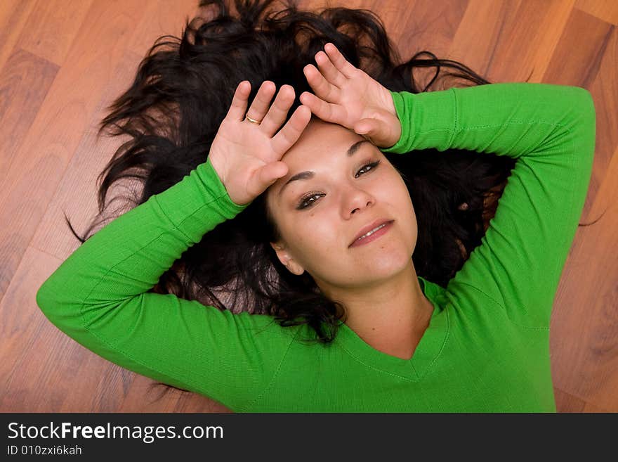 Brunette woman lying on the floor. Brunette woman lying on the floor