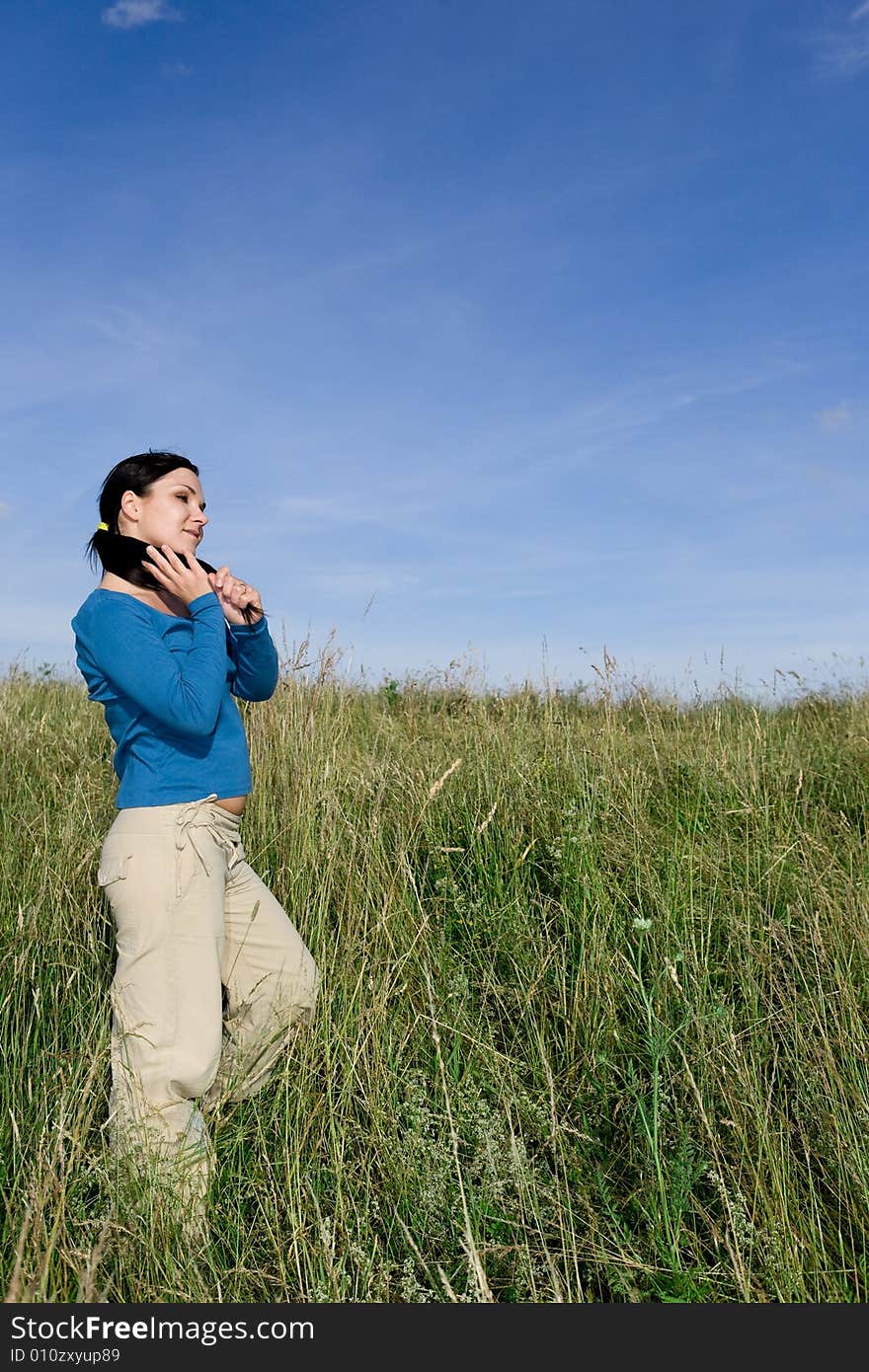 Attractive brunette woman relaxing on meadow. Attractive brunette woman relaxing on meadow