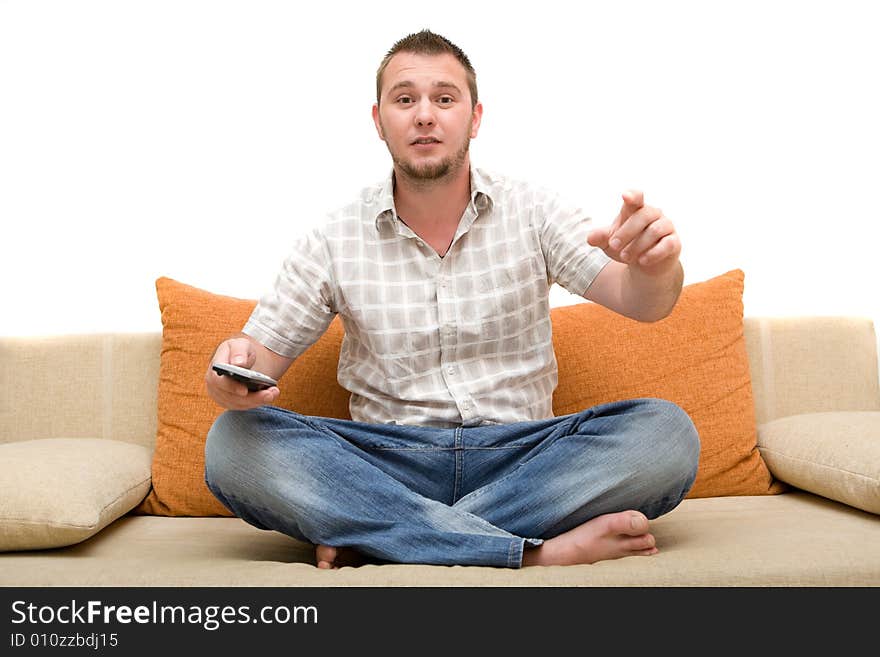 Casualman sitting on sofa with remote control. Casualman sitting on sofa with remote control