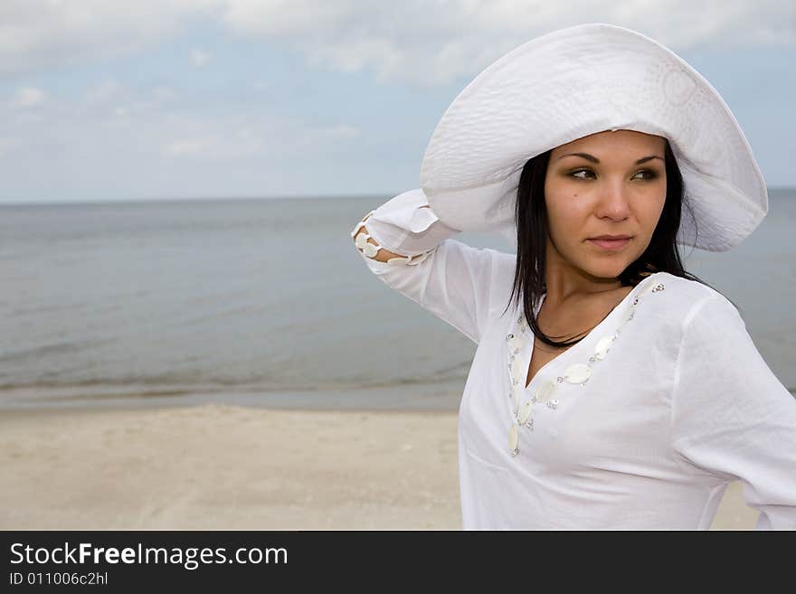 Attractive brunette woman relaxing on beach. Attractive brunette woman relaxing on beach