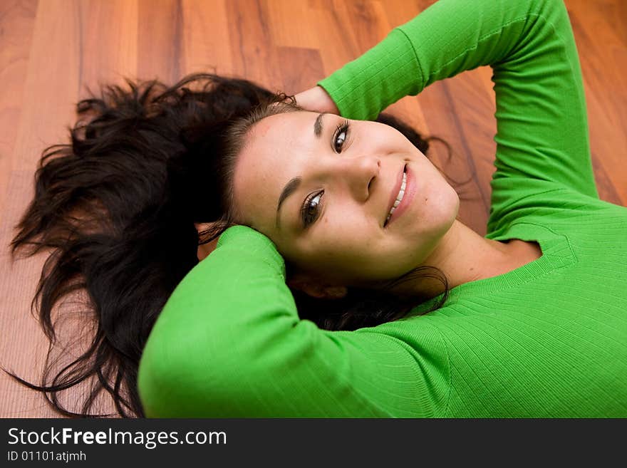 Brunette woman lying on the floor. Brunette woman lying on the floor