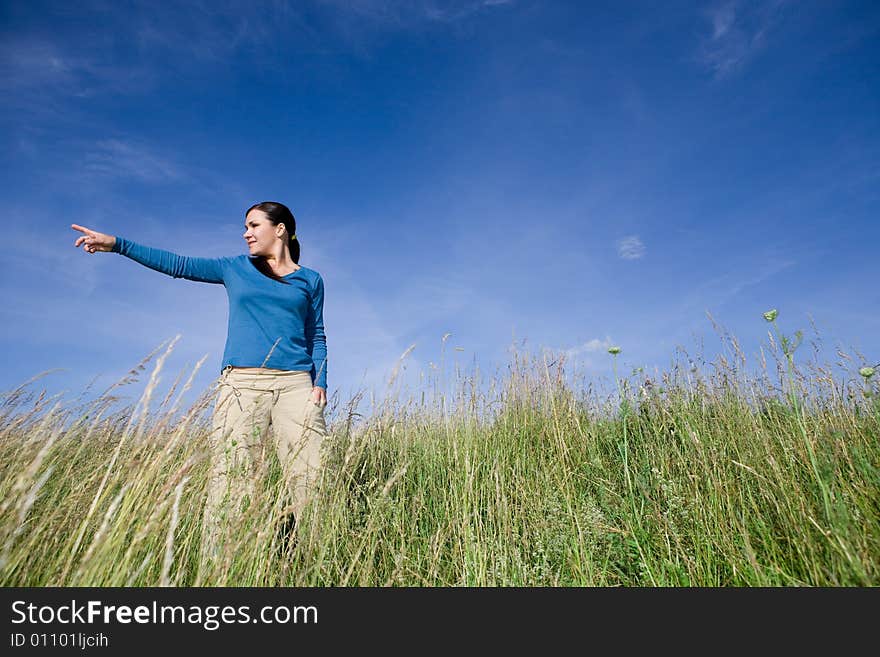 Attractive brunette woman relaxing on meadow. Attractive brunette woman relaxing on meadow