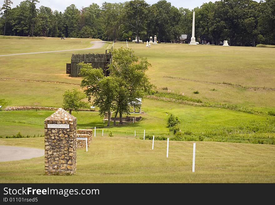 The stone marker stands at the S.W. conner of the Andersonville Stockade prison and the line of white posts to the right mark the position of the dead line. The stone marker stands at the S.W. conner of the Andersonville Stockade prison and the line of white posts to the right mark the position of the dead line